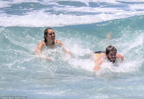 Miley Cyrus wears a bikini and plays with her boyfriend on the beach after rumors of a secret marriage