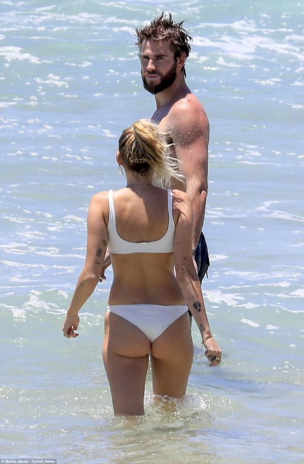 Miley Cyrus wears a bikini and plays with her boyfriend on the beach after rumors of a secret marriage